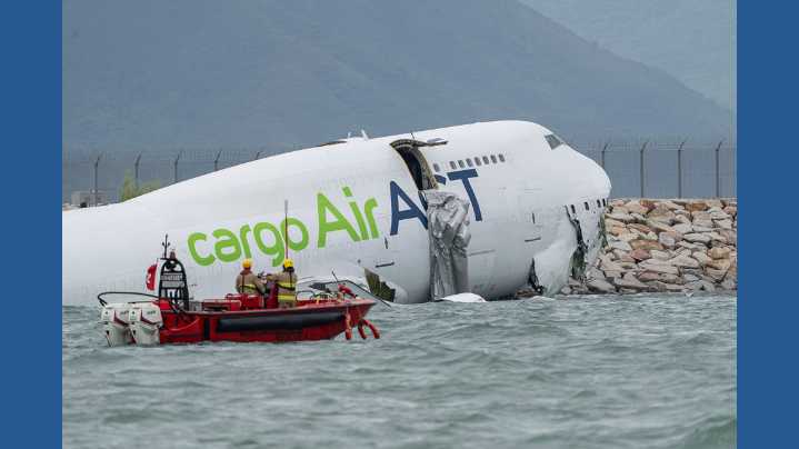 A cargo aircraft skids off a Hong Kong runway into the sea, killing 2 people