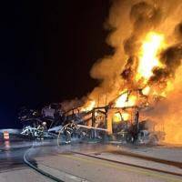 Truck hauling vehicles burns along I