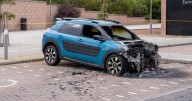 Two men charged after car found on fire outside Scots prison