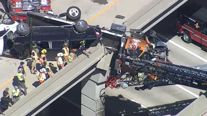 Trucker rescued after crash left flatbed tow truck hanging off overpass at U.S. 75 & Hwy 121