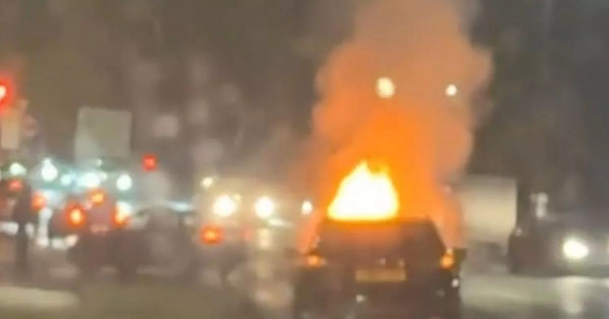 Firefighters rush to scene after car engulfed by flames
