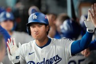 Ohtani hits 2 homers for Dodgers in playoff opener against Reds