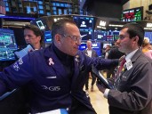 Most U.S. stocks rise after swinging through another erratic day