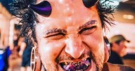 Tattoo addict with devil horns threatened in street as people want to smash his face in