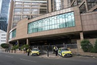 Anti-migrant protesters laugh as firefighters rush to Brittania hotel in Canary Wharf