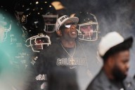 Colorado fans storm field after win over No. 22 Iowa State, Deion Sanders loves it but fine may loom