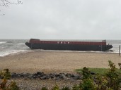 VIDEO: Barges wash up onto beach in Milford