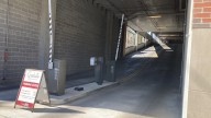 Woman dies after SUV crashes into wall exiting hotel parking garage