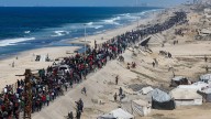 Tens of thousands of Palestinians walk to Gaza City as Israel withdraws