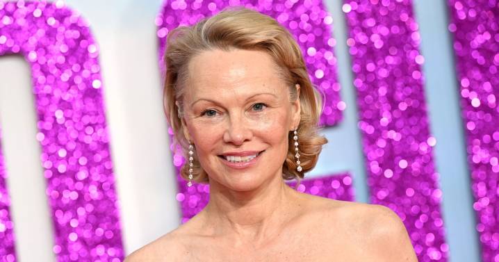 Pamela Anderson Debuts New Red Hair at Paris Fashion Week