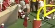 Football player suffers horror injury after crashing into brick wall as cameras cut away