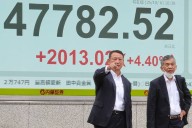 Asian markets mostly higher in quiet holiday trading after AI deals push Wall St to more records