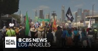 Immigration activists and demonstrators march across Sixth Street Bridge to protest ICE