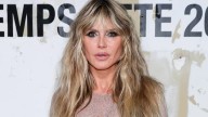 Heidi Klum reveals her bare chest in a completely see-through white dress and debuts jarring new grillz in Paris
