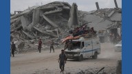 The Latest: Palestinians journey back home as aid convoys enter Gaza and truce holds