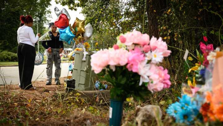 People pay respects at memorial for three E.E. Smith students