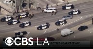 A man with a rifle at the 105 Freeway South Los Angeles overpass is in custody