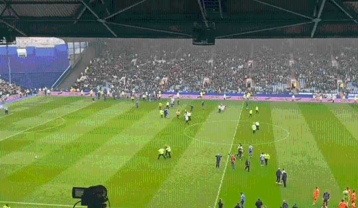 Championship match stopped as fans invade pitch ten minutes after kick