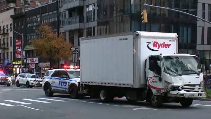 NYC truck hits parked van, pushing it onto sidewalk and injuring 9