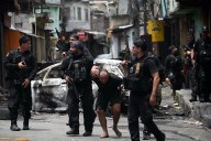 At least 60 people die in massive police raid in Rio de Janeiro, official says