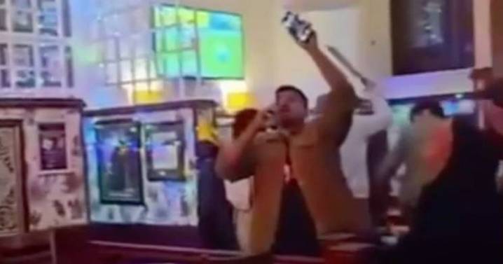 Machete thug storms Glasgow pub and hacks man as horrified punters watch