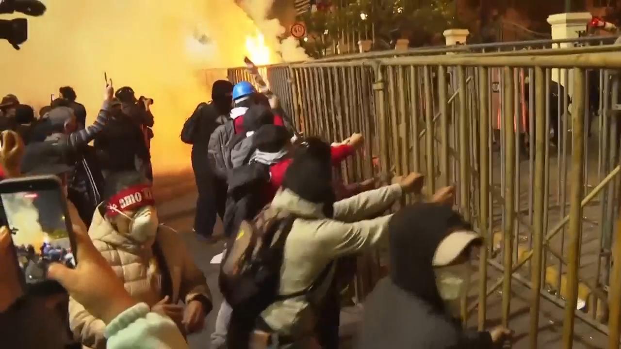 Protesters and riot police clash as protests in Peru's capital turn violent